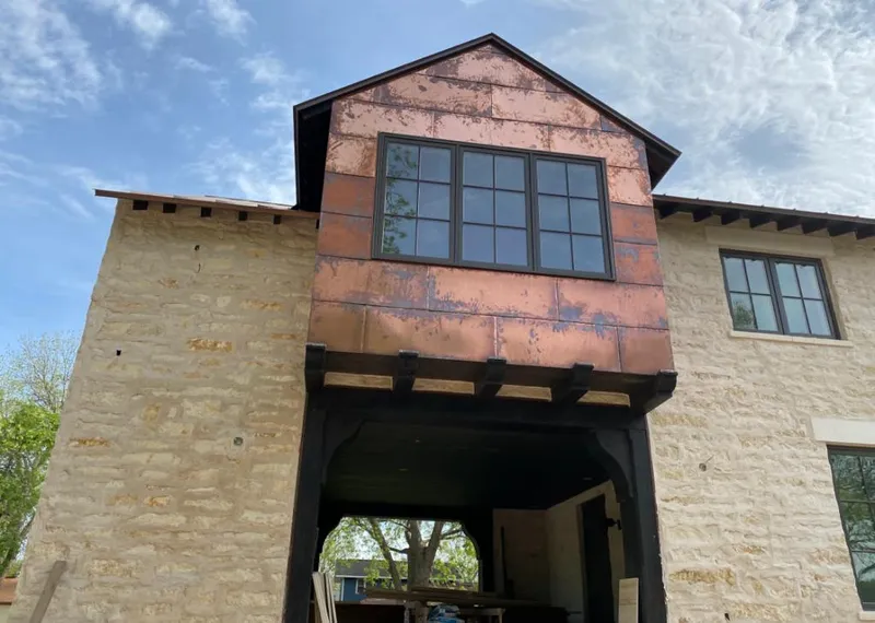 Copper metal panel facade on a stone building for Skylight Installation in Lenexa